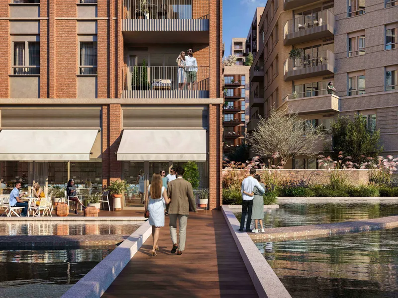 Waterside walkway with cafe awnings and people passing