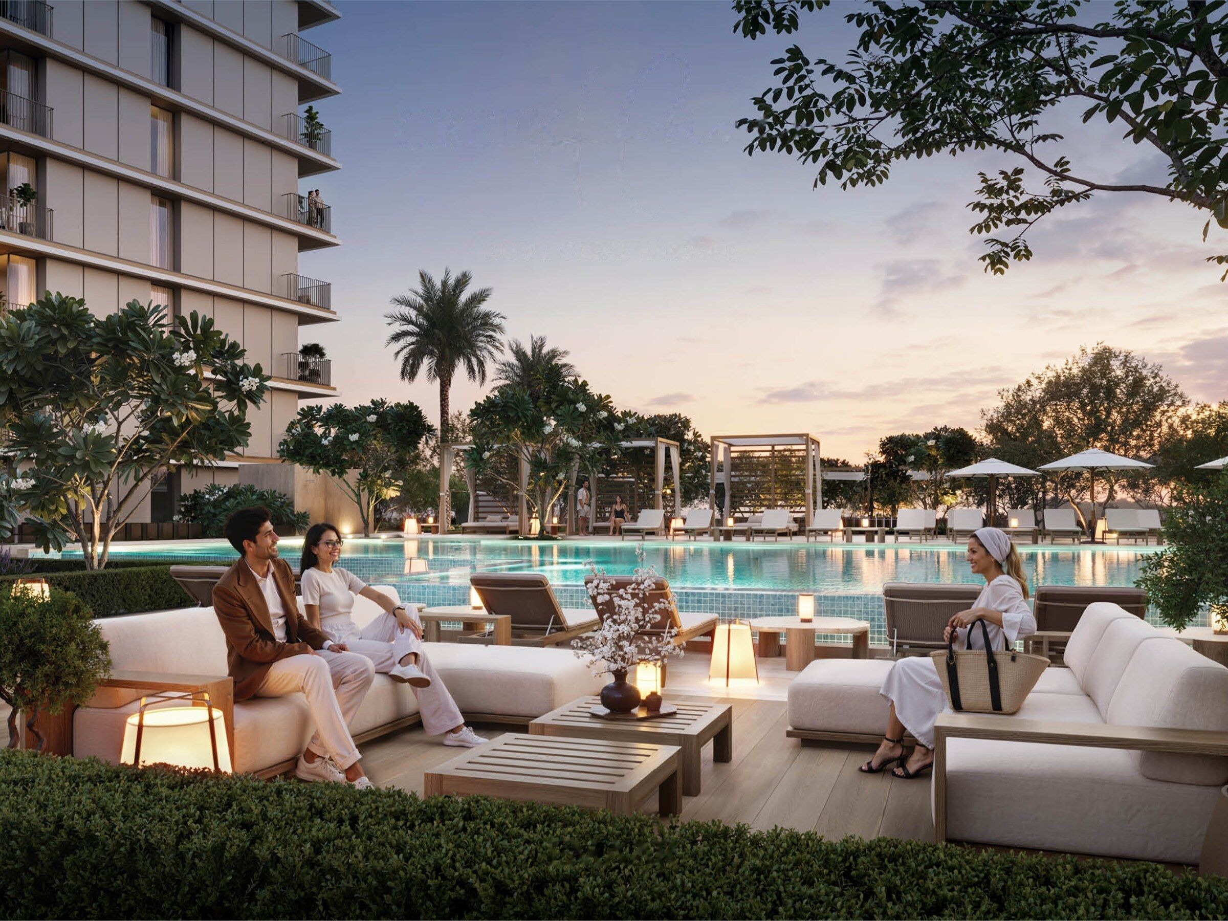 Evening view of the pool terrace with lounge seating and palms