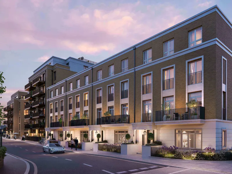 The street elevation at dusk with the ground floor lit