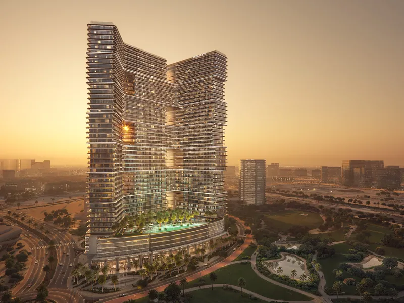 The tower at sunset above the green of the district